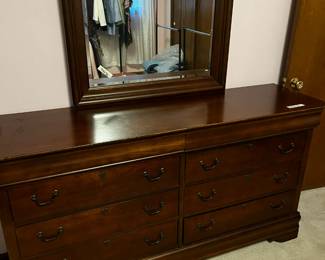 #16	Broyhill Dresser with mirror 8 drawers 68x19x35 (made in USA) small watermark on side beveled mirror 36x40	 $275.00 
