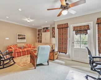 Henredon 80’ Sofa covered in Coral Gold Stripe Fabric; Hitchcok Black Wood Rocker; Trunk End Table in Ash; Stickley Club chair covered in Green Woven Fabric Maple; Mesh Desk Chair