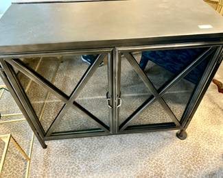 Three outdoor metal black cabinets.