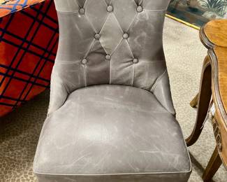 Four gray leather tufted chairs with brass studs. Beautiful! Retails for $2000. Not our price!