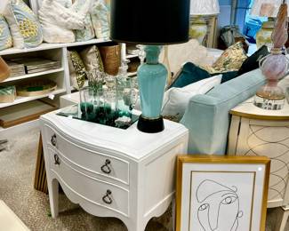 Tommy Bahama end table or nightstand. Retails for $1079. Art all around. Love the vintage MCM Turquoise lamp.