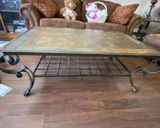 Wrought iron base with a marbled tiled top  