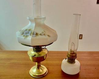 Lot 037-MC: Two Vintage Lamps

Features: A charming pair of vintage lamps:

•	75th Anniversary Aladdin Hurricane lamp 
o	Aladdin Lamp 75th Anniversary Hurricane Lamp. These limited-edition Anniversary lamps were given by Aladdin to their employees in 1983. This lamp comes complete with its original Model 23 burner. Burner appears to be complete with all original parts including a (nub of a) wick and flame spreader.
•	Electrified brass-based oil-lamp with Aladdin chimney 
o	Features a floral-patterned milk-glass shade 

Dimensions: For reference: taller lamp is 23”H

Condition: Good pre-owned condition. No chips or cracks in the glass of either chimney, the base and shade.

