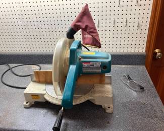 Lot 013-GAR: Makita LS1040 10” Compound Miter Saw
Features: 
•	Powerful 15 AMP direct drive motor for improved performance; 4,600 RPM 
•	Dual-post compound pivoting arm 
•	Miter cuts 0°-45° left and 0°-52° right 
•	Positive miter stops at 9 settings: 15°, 22.5°, 30°, 45°, right or left and 0° (90° cuts) 
•	Bevel cuts up to 45° to the left 
•	Provides a large capability with cuts 52 degrees right and 47 degrees left with 9 positive stops at 15, 22-1/2, 30, 45 degrees left or right and 0 degrees
•	Durably designed with a machined aluminum base, dual aluminum base, dual slide rails and a carbide tip blade
•	Compare new at Amazon.com for $339 plus tax!
Condition: Good pre-owned working condition.

