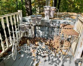Lot 093-PAT: Metal Yard Art Assortment #2
Features: 
•	2 umbrella stands
•	1 bicycle plant holder
•	2 metal table plant stands
•	2 flower holders for wedding décor
•	1 decorative metal wall hanging
Dimensions: For reference: Wedding flower holders – 40”L x 49”H; 2 table plant stands – 12”square top x 29”H
Condition: Good pre-owned condition. Some items exhibit weathered patina and varying degrees of rust from exposure to the elements.
