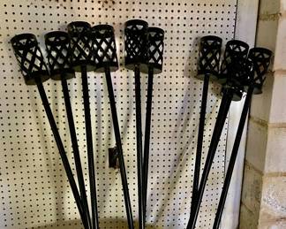 Lot 043-GAR: Tiki Torch Assortment
Features: 
•	10 metal Tiki Torch poles
•	Tiki torch oil
•	Note that poles do not have canisters, just the container to hold canisters

Dimensions: Poles are about 5 1/2’ tall
Condition: Good pre-owned condition
