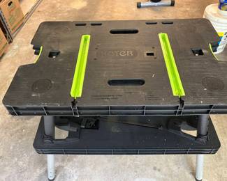 Lot 018-GAR: Keter Folding Work Table
Features: 
•	Instant Workspace Anywhere: Ready to work in just 30 seconds with no assembly required, this lightweight worktable is perfect for DIY projects, home improvements, and job sites. 
•	Robust & Spacious: With a large work surface supporting up to 1,000 lbs. and 12" clamps that can be installed horizontally or vertically, you can tackle heavy-duty tasks with ease and keep your materials secure for any job.
•	Versatile Design: Ideal for miter saws, woodworking, and various other tasks, the quick-opening and folding system ensures seamless storage and transport, allowing you to set up and pack up quickly.
•	Durable & Weather-Resistant: Constructed from weather-resistant polypropylene and heavy-duty resin with aluminum legs, this workbench won’t rust, peel, or dent for reliable performance in any environment.
•	Compare new at Amazon.com for $109.99
Dimensions: 21.65"D x 33.46"W x 29.75"H; 27 lbs.
Condition: Excellent pre-owned condition.
