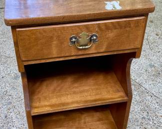 Lot 031-GAR: Ethan Allen Nightstand

Features: 
•	Made in 1982
•	Has a glossy finished top.
•	Hardwood construction; backing is pressed board
•	Could function as a side table

Dimensions: 17”W x 14”D x 28.5”H

Condition: Good pre-owned condition. It’s a solid piece. Some nicks, scratches and finish wear are visible. Adhesive residue on top surface (remnants of a sticker?) could easily be removed.
