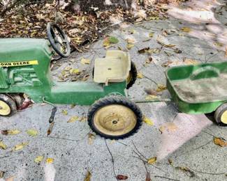 Lot 096-BH: Vintage Metal John Deere Pedal Tractor

Features: 
•	Metal John Deere Pedal tractor with pull-behind trailer
•	Well-loved and well-used

Dimensions: Tractor: c. 35” L; Trailer (with tongue), c. 30”L


Condition: Fair pre-owned condition. Some extensive surface rust is present in the trailer. The tractor has some rust spots.
