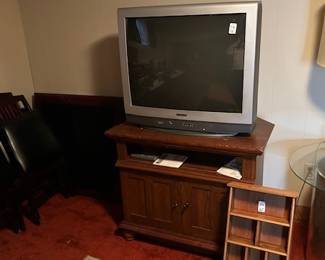 tv and tv stand.  gold coffee table with glass top