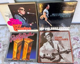(4) Musical Box Sets
The Bruce Springsteen box set is three cassette tapes and box appears unopened and plastic not torn. Also includes - Ray Charles, Hank Williams, and 52 number 1 hit party rock