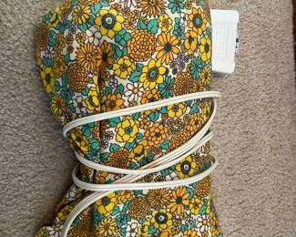 Vintage heating pad with original cover.