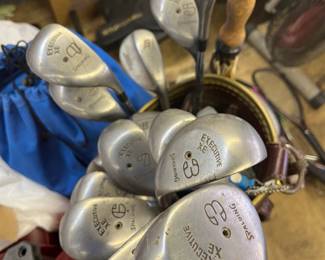 One of 3 sets of golf clubs.