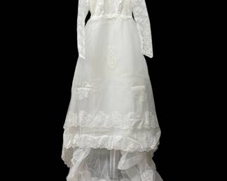 1972 Vintage wedding dress features: embroidered lace, high neck with pearl detail, long sleeve, tulle train and Handmade veil. Petite size 3 