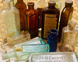 Large collection of patent medicine bottles including Hadacol, Katz and Besthoff and Hobo Medicine of Beaumont. 
