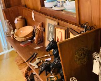 Cypress church pew is filled with hitching posts (2) and religious pictures--can you see the old glass Jack Daniel's  one gallon bottle at the end of the pew