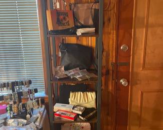More evening bags and purses on tower iron and wood bookcase