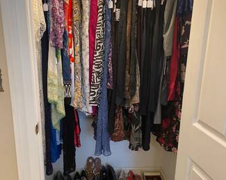 Closet of designer clothes and shoes
