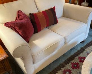 New cream upholstered loveseat
