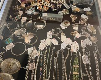 Large collection of sterling bracelets and cuffs and broaches