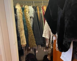 Hall closet of fur , faux fur, and leather coats and jackets
Nice selection of boots and shoes