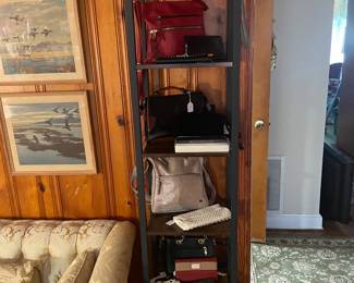 Tower iron and wood bookcase of vintage and designer purse , handbags and wallets