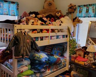 Bunk beds, some kids clothing, large stuffed animals,