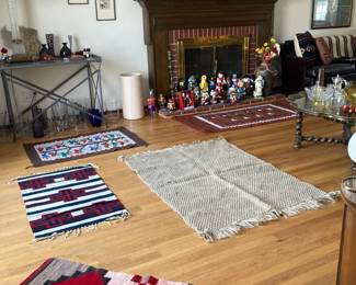 Mexican Rugs, console table with glass top, Vases under table, Nutcrackers on hearth