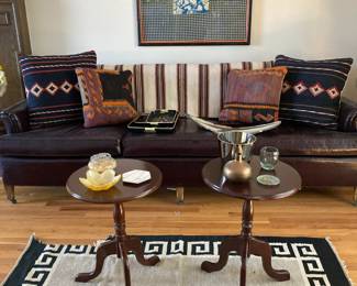 Leather Sofa with pillows, small pedestal tables, rugs