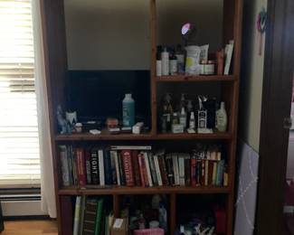 Book shelves with bath accessories and small TV