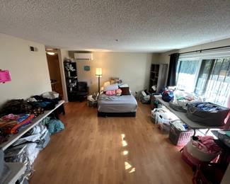 master bedroom is filled with clothes