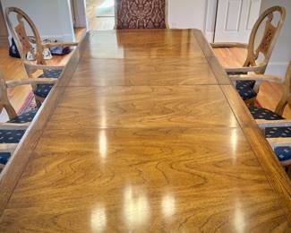 Table and 8 chairs. Table made in North Carolina. Six upholstered low chairs and two red upholstered grandfather chairs.