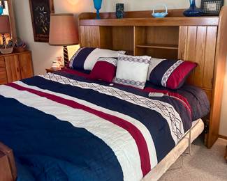 King sized bed with wood shelving headboard