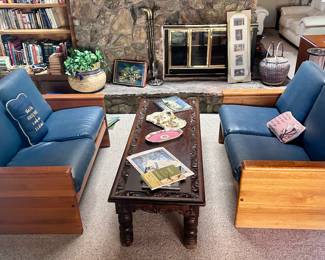 Blue leather lounge sofas and vintage dark wood carved long coffee table
