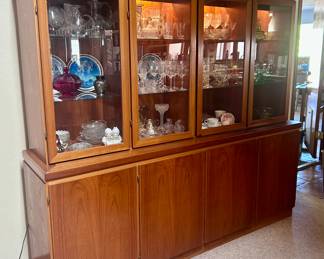 Wood display cabinet with lights and glass display cabinet doors. Lots of room for storage in lower cabinets