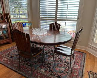 There are two captains chairs and a matching small round table in the living room that go with this set