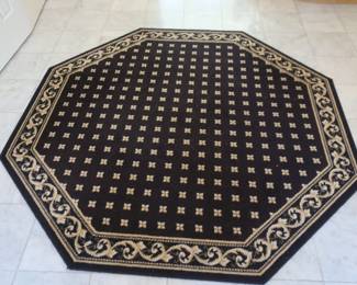 Eight  sided  rug.  It  is  gold  and  dark  blue.