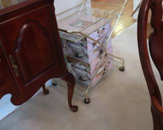 Gold tone serving  cart  with  two  glass  shelves.