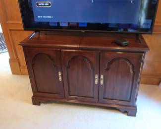 Storage for stereo  units. It  is  cherry and  may  be  made  by  Stanley.