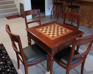 Game  table with  four  chairs.  It  is  31"  square.