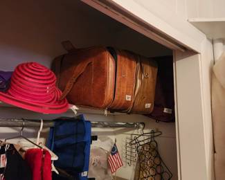 Suitcases, hats, & decor items in closet 