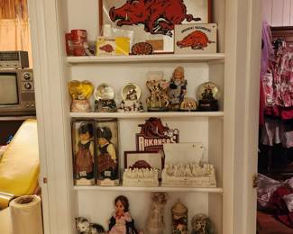 Razorback items on top shelf - snow globes, dolls, & candles 