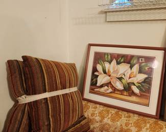 Pillows & more pillows on sofa with framed magnolia picture above 