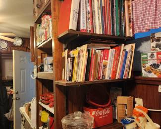 This is part of kitchen area - lots of cookbooks & collectibles, Coca-Cola container