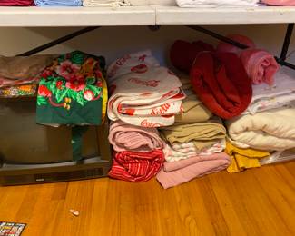 Small TV on left, linens 