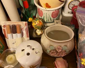 Clocks, candles, candle holders, wooden flowers at back