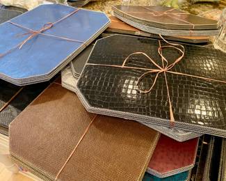 ASSORTED LEATHER TYPE PLACEMATS. ORIGINAL PRICES ARE $35.-50 EACH. SALE PRICES ARE $5.-15.
