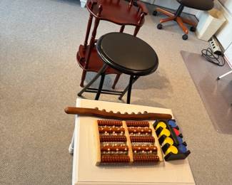 White Side Table, Foot Massager Roller,  Bead Massager Roller Guasha Wood Stick, Polker Chips. Black Padded Folding Stool, Plant Stand.