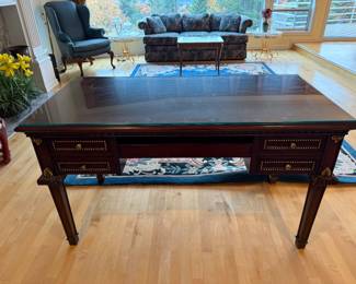 Mahogany Writing Desk with gold  trim accents and glass protective top. L 55in | D 27.1/4in | H 31.1/2in