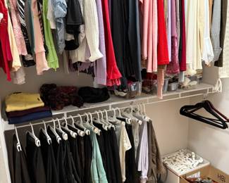 Women's Clothing - Blouses, Sweaters, Slacks, Leather Pants. Also Men's Polo Sweaters folded on rack.